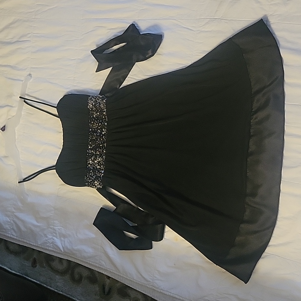 Woman's black satin party dress. Spaghetti straps with satin tie in back. Lined.